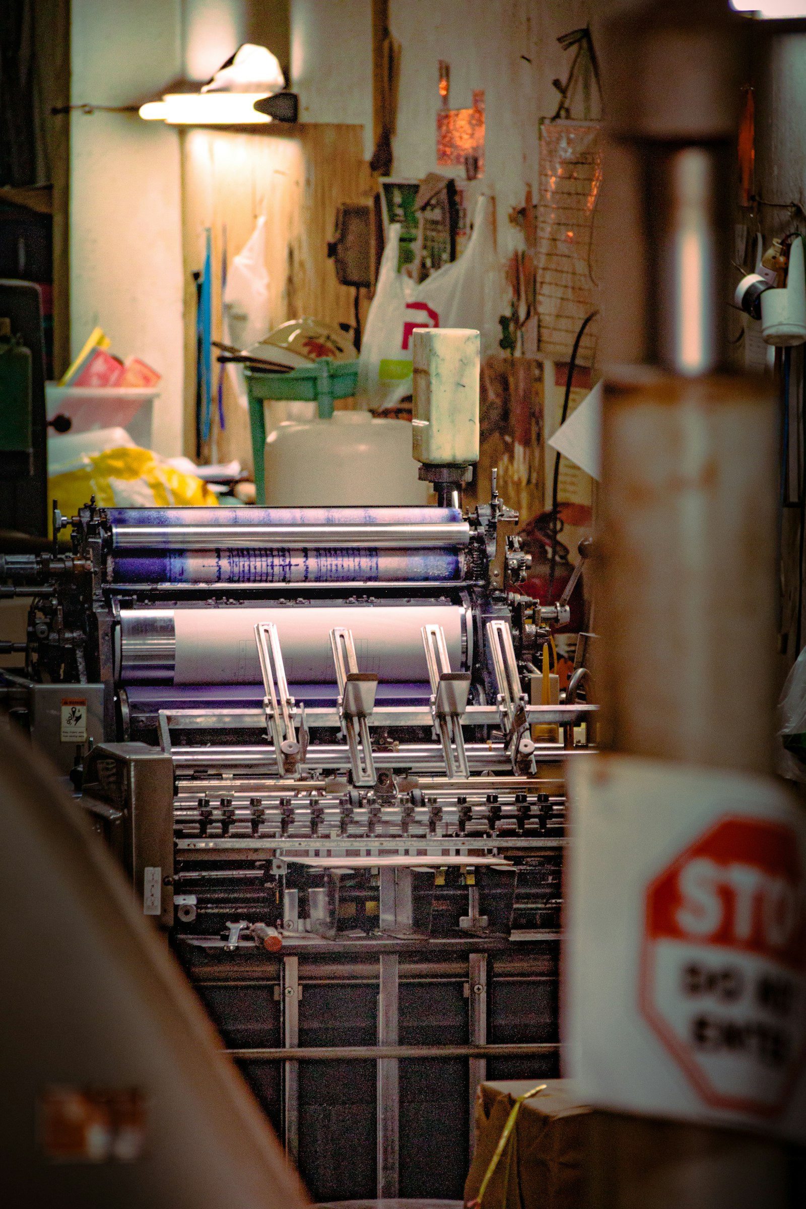 Ink rollers on an offset press in a working print shop. Offset litho still produces the bulk of the world's physical print volume.