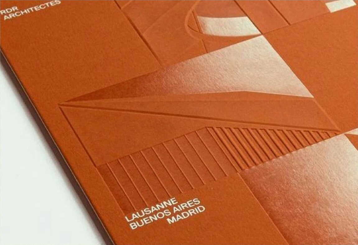 Orange embossed book cover with UV relief and fine line detail on heavy carton board
