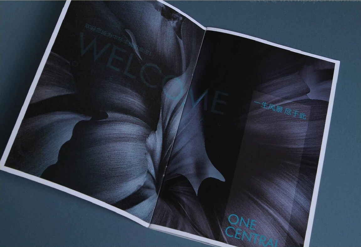 Blue brochure spread finished with matte varnish and a light sheen, printed for property marketing