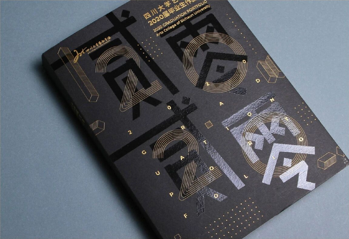Matte black portfolio with gold and spot UV artwork, gloss accents sitting on a matte varnish base